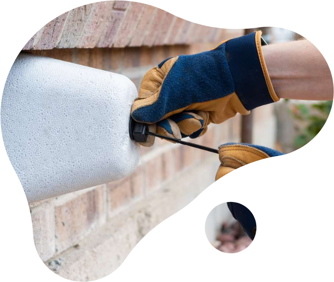 a person winterizing a spigot