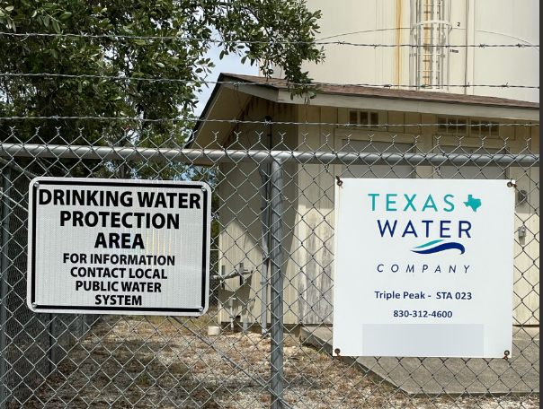two signs on a fence - one that reads drinking water protection area